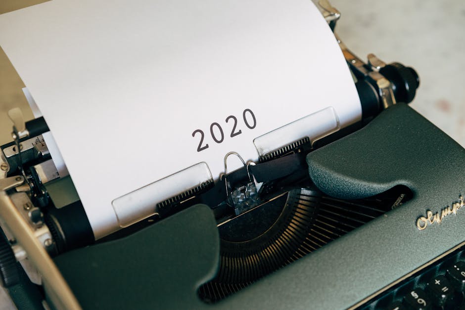 Close-up of a vintage typewriter with the year 2020 typed on paper, symbolizing writing and history.