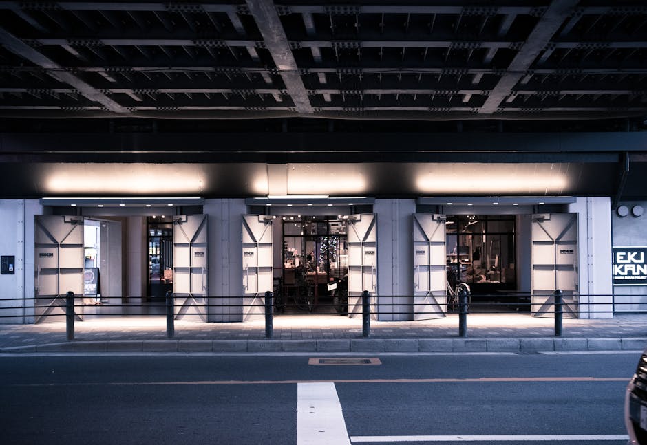 A stylish urban street scene at night with a modern lit building facade.