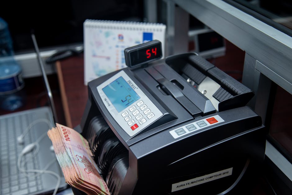 Automatic money counter in a modern office counting banknotes efficiently.