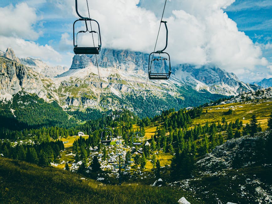 Breathtaking view of the Dolomites and lush green valleys from a cable car in Cortina d'Ampezzo, Italy.