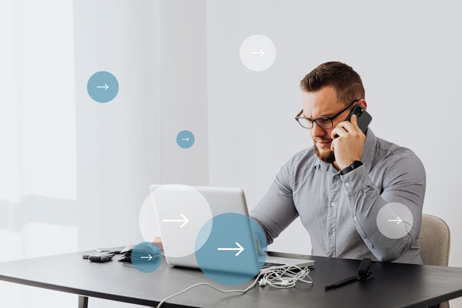 Professional man multitasks with laptop and smartphone in home office environment.