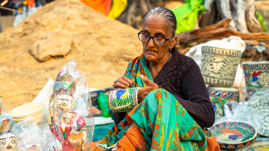 Senior woman crafting traditional art outdoors, showcasing cultural heritage.