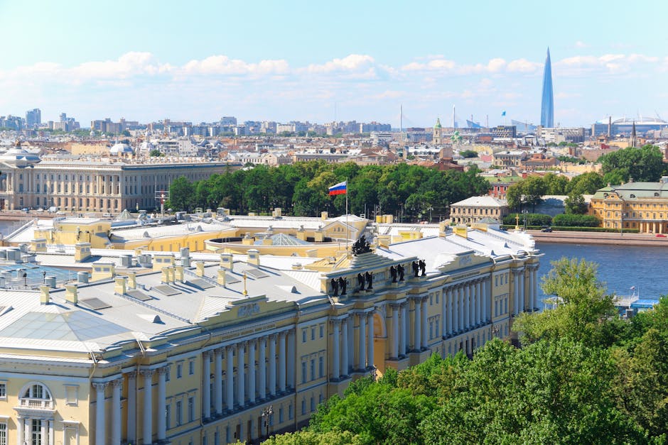 Aerial view of St. Petersburg featuring the Senate and Synod Building and Russian flag.