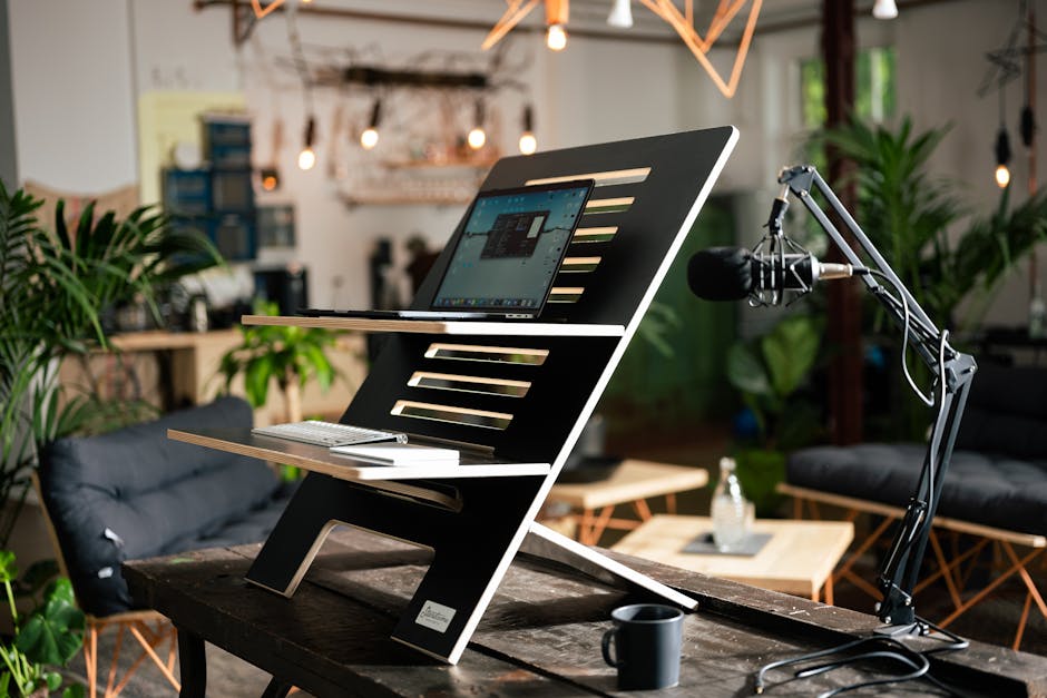 Elegant workspace featuring a laptop, microphone, and contemporary decor.