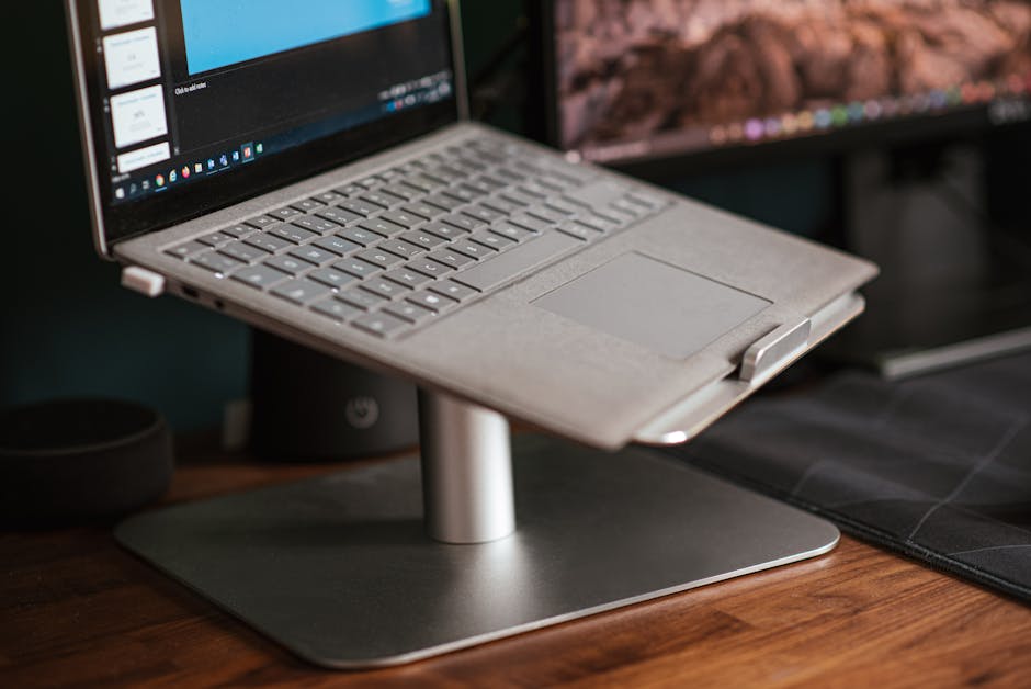 Sleek laptop on ergonomic stand, perfect for a modern workspace.