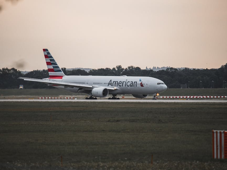 American Airlines plane on the runway at Munich Airport during sunset.