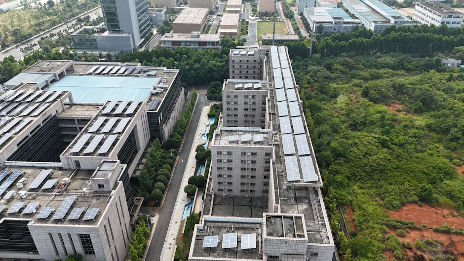 Aerial urban landscape with solar-panel rooftops and green spaces.