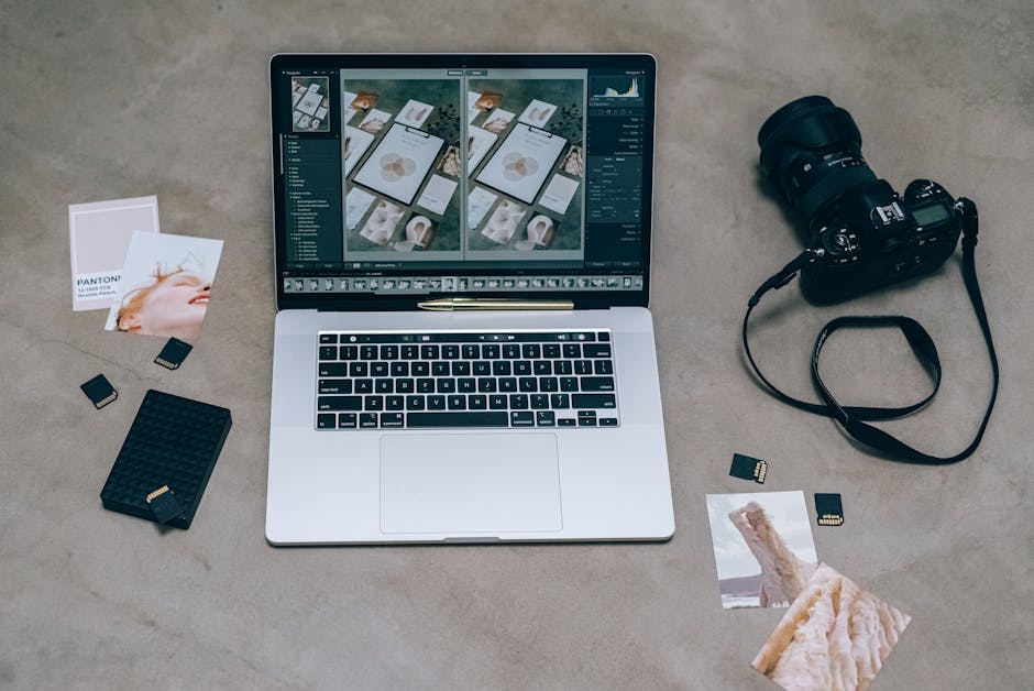 A top view showing a laptop with photo editing software, DSLR camera, and memory cards.