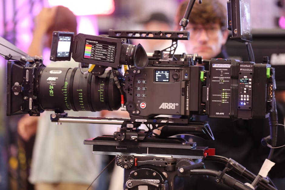 High-end cinematic video camera setup in a filming environment with crew in the background.